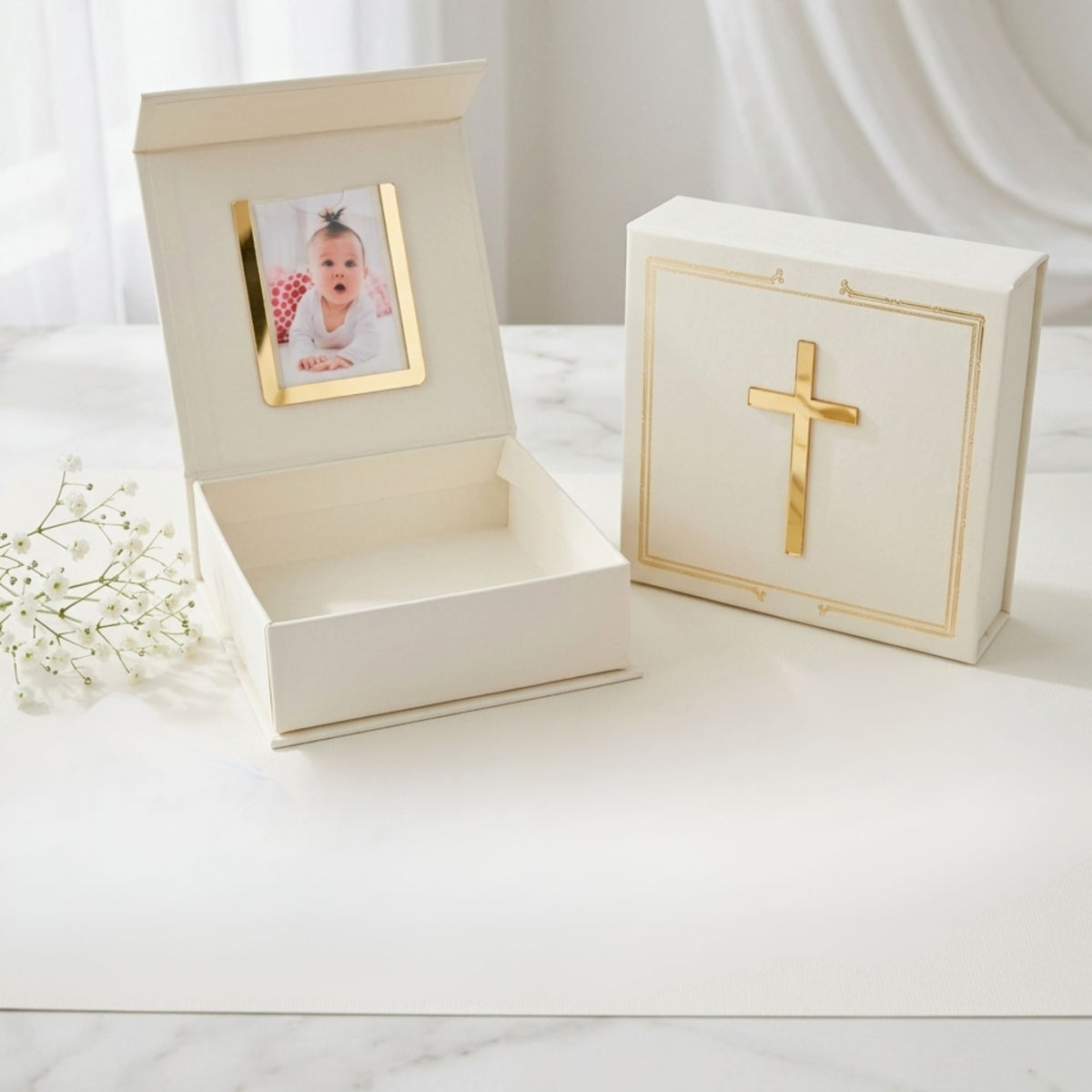 White keepsake box with gold accents featuring a cross design on a white surface.