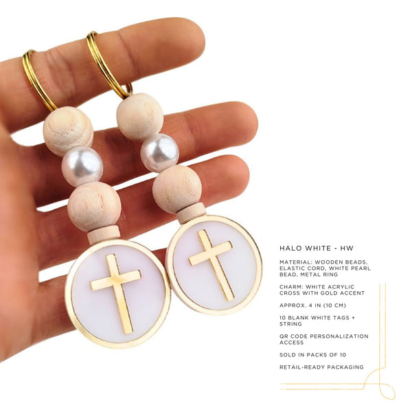 Hand holding two kechains wooden bead charms with white acrylic crosses on a white background