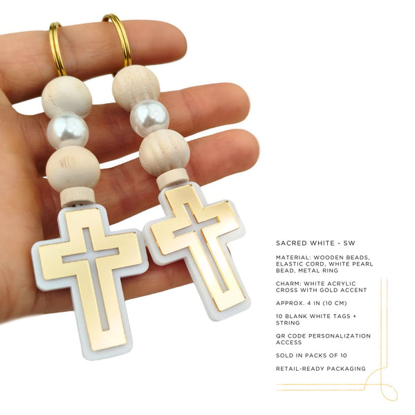 Hand holding a rosary with gold crosses and white beads on a white background