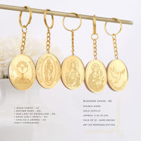 Set of gold keychains with religious designs on a white background baptism party favors