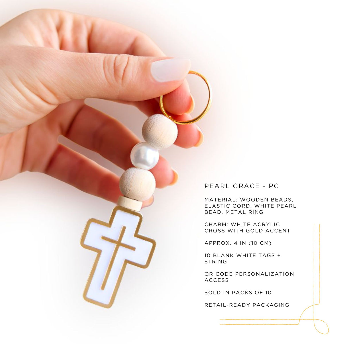 Hand holding a pearl grace keychain with cross charm on a white background