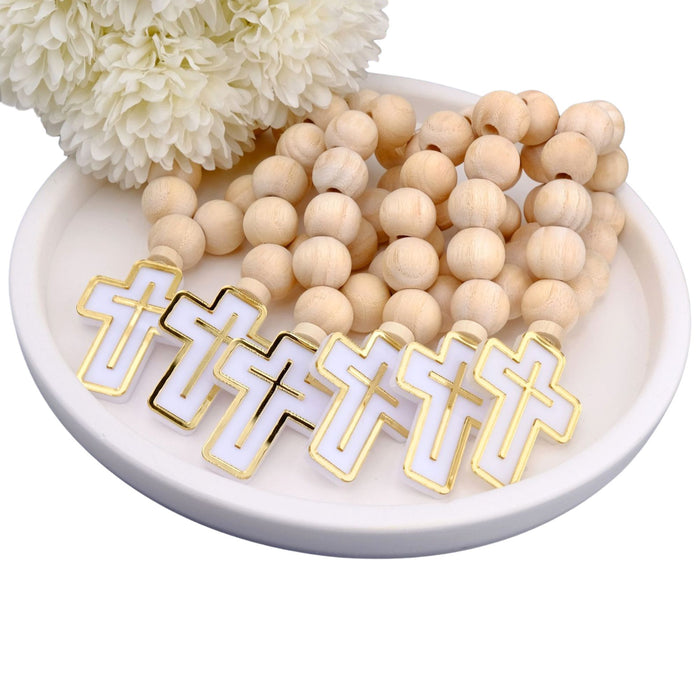 Wooden beaded mini rodsary with cross pendants on a white dish with flowers in the background