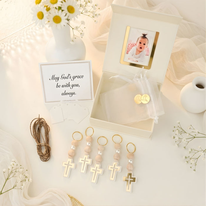 Decorative items including cross-shaped charms, a photo frame with a baby picture, and a card on a soft surface.