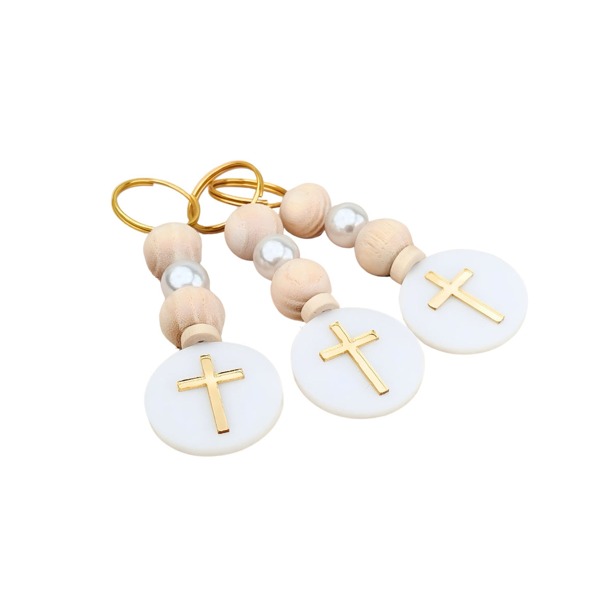 Decorative baptism favor keychain with wooden beads and gold crosses on a white background
