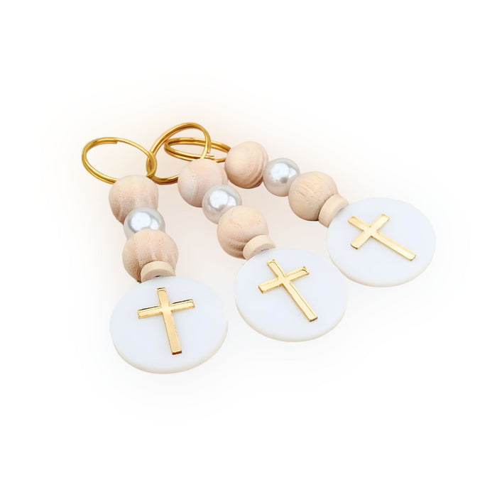 Pair of keychains with wooden beads and gold crosses on a white background, event favors