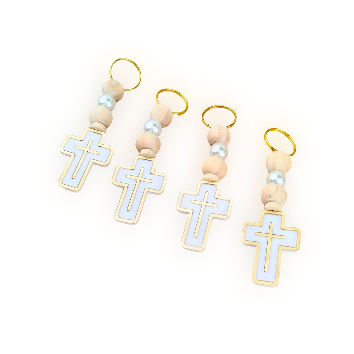 Set of four cross-shaped charms on wooden beads with gold loops against a white background