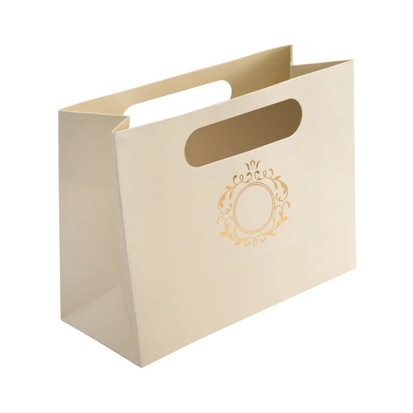 Beige paper bag with a gold details on a white background