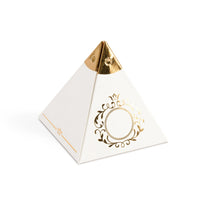 Pyramid-shaped white candy favor box with gold accents on a white background