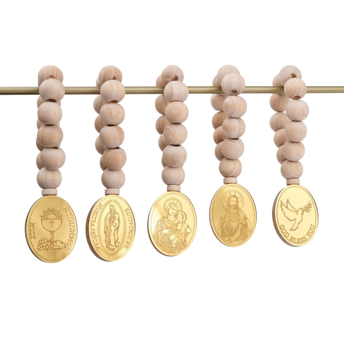Set of five wooden beaded mini rosaries with gold religious medallions on a white background