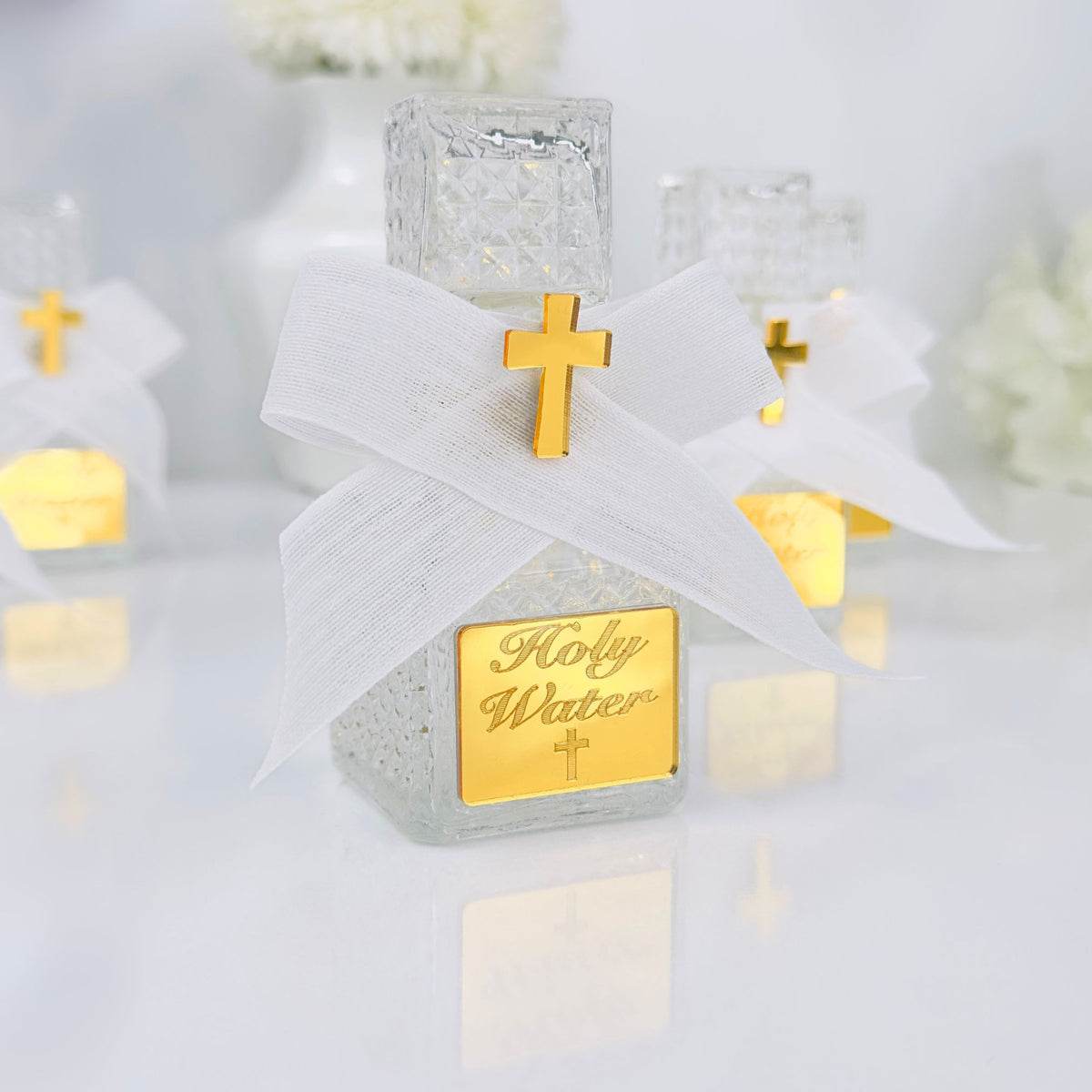 Holy water container with gold cross and 'Holy Water' text on a white background