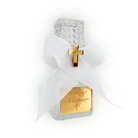 Glass holy water bottle labeled 'Holy Water' with a gold cross on a white background