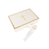 White baptism keepsake box with gold cross and white bow on a white background