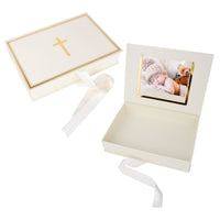 Decorative box with a cross on top and a photo of a baby inside, on a white background.