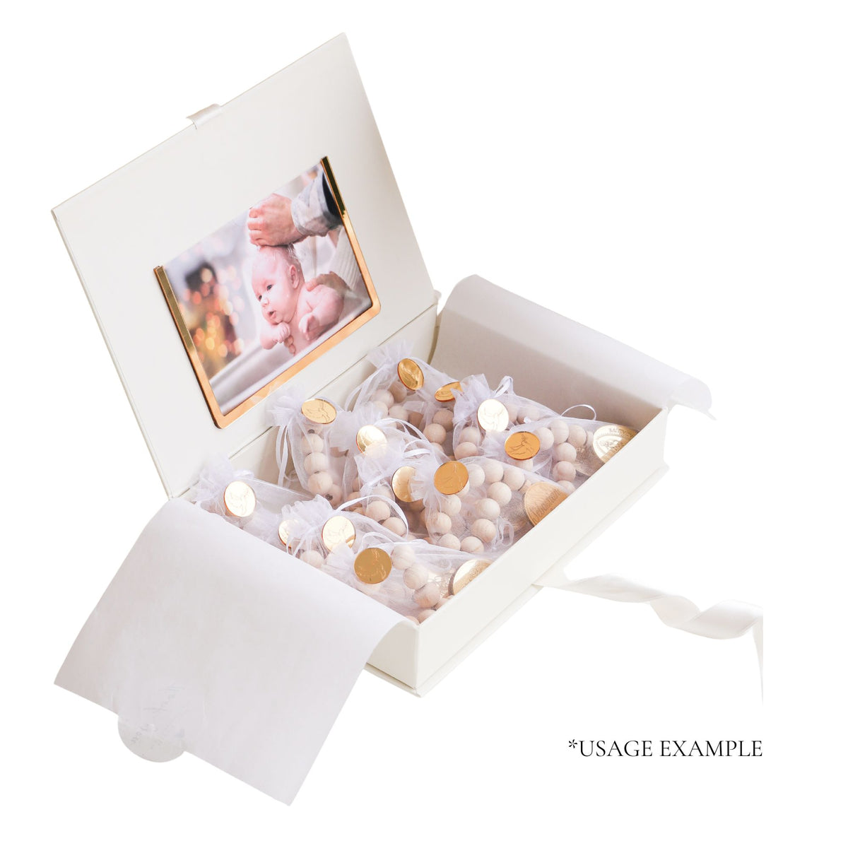White gift box with baby photo and decorative items on a white background