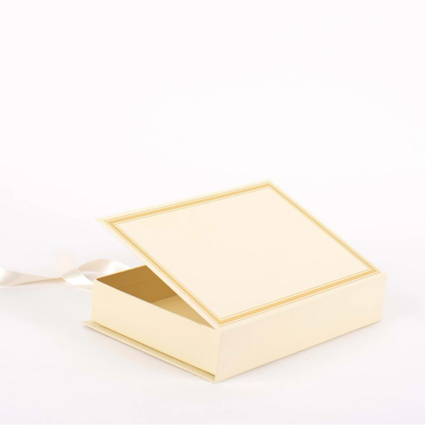 Cream-colored keepsake box with a gold rim on a white background