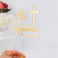 Gold 'My Baptism' cake topper with a cross on a white background