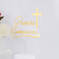 Gold 'Primera Comunion' cake topper with a cross on a white background
