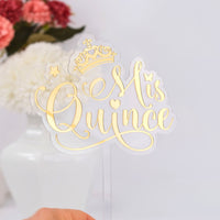 Decorative cake topper with 'Mis Quince' text and crown on a white background